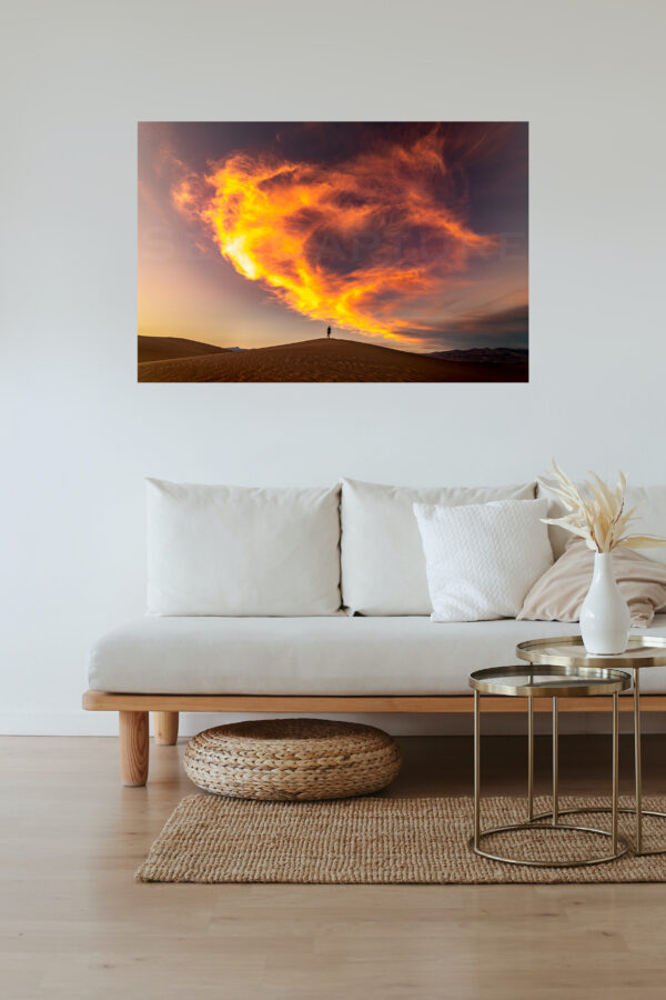Frame of an on-fire like sky in Death valley displayed on the wall of a living room.